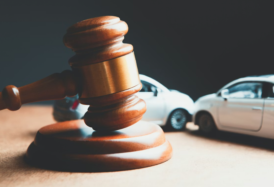 Miniature cars and a wooden gavel.